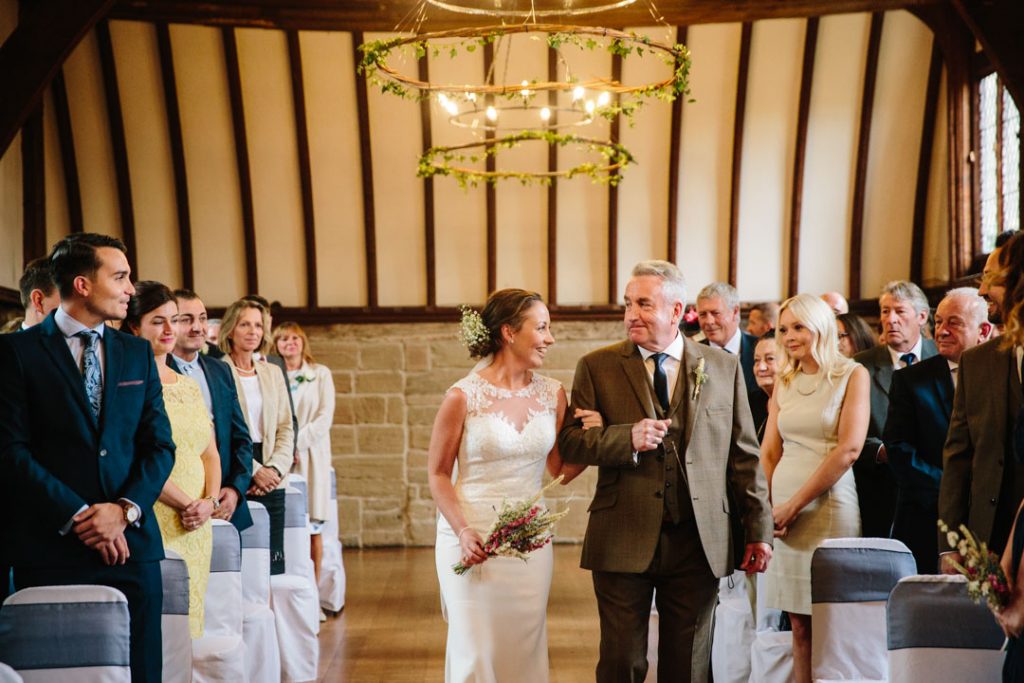 Bride walking down the aisle with her Dad, Lord Leycester Hospital