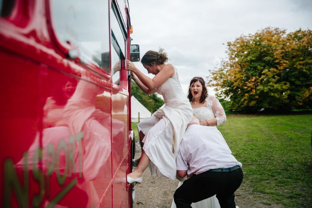Bride climbing into driver seat of bus