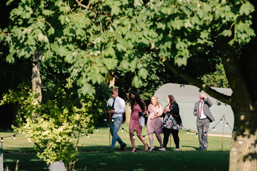 Guests walking to the tipi for wedding reception at Dovecote Barn