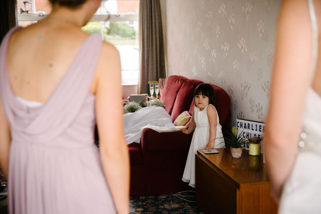 flower girl sees bride in her dress