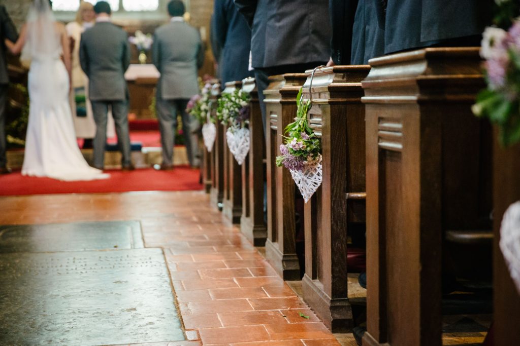 Pew flower details in church wedding