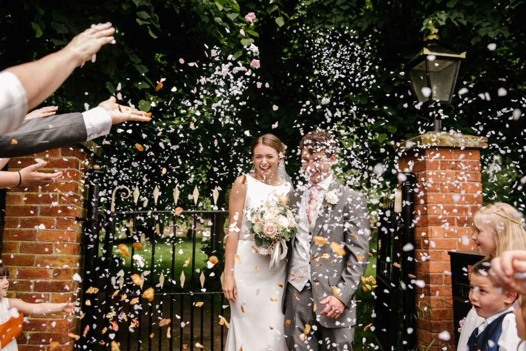 Bride and groom confetti shot outside church