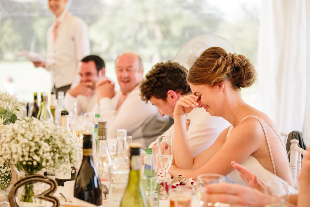 Bride cringing at the wedding speeches