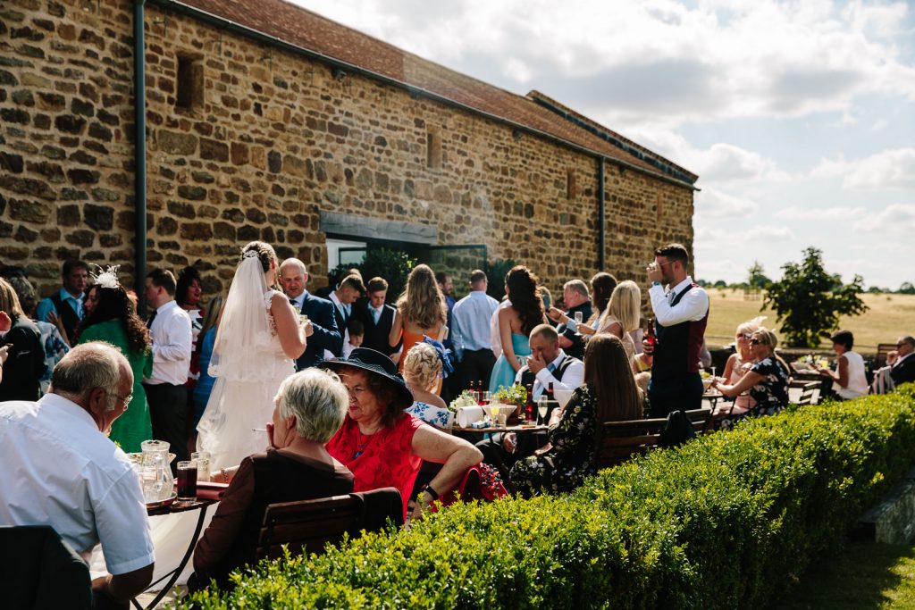 wedding guests in the courtyard at dodford Manor