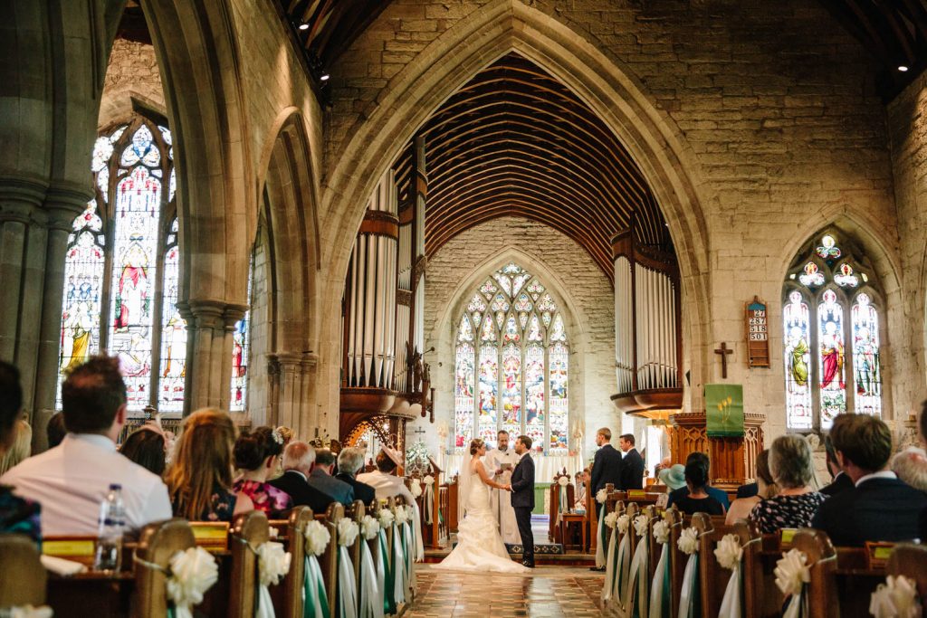 Bride and Groom at the alter at Tanworth in Arden church 