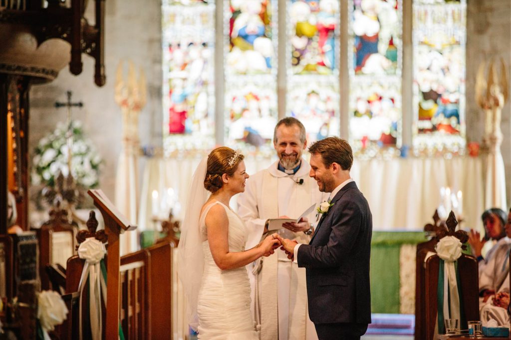 Bride and Groom exchanging vows in Tanworth in Arden church 