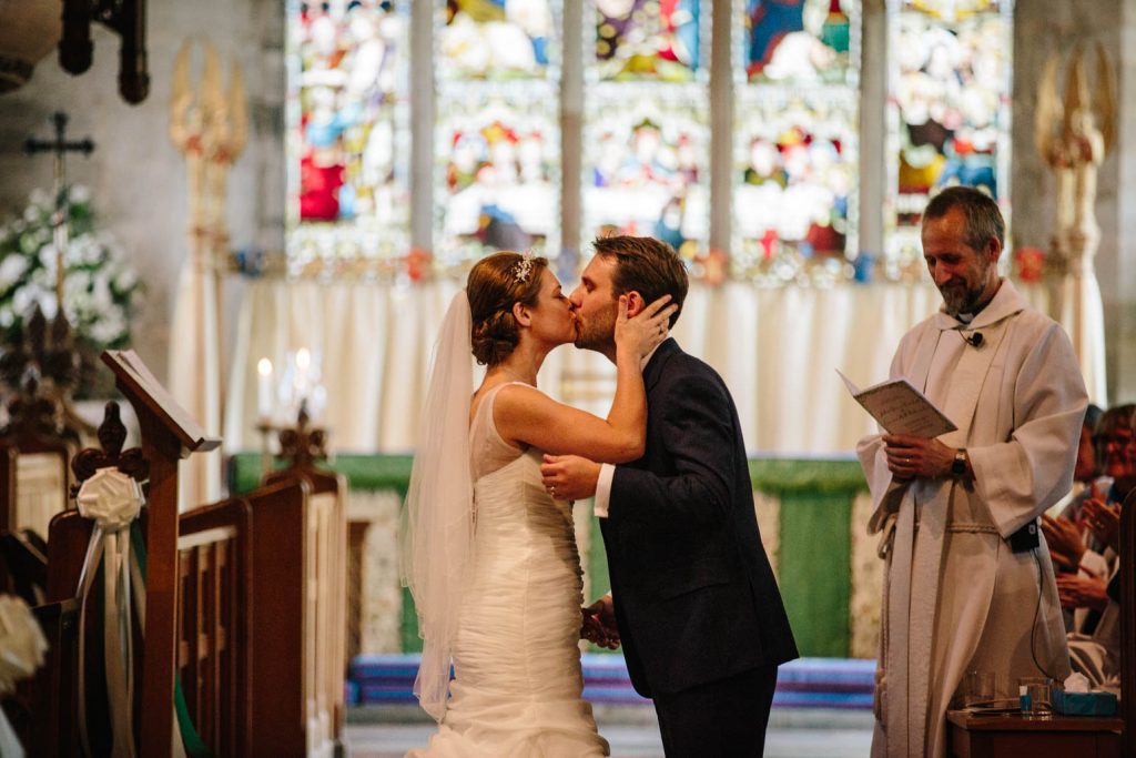 First kiss as husband and wife in Tanworth in Arden church 