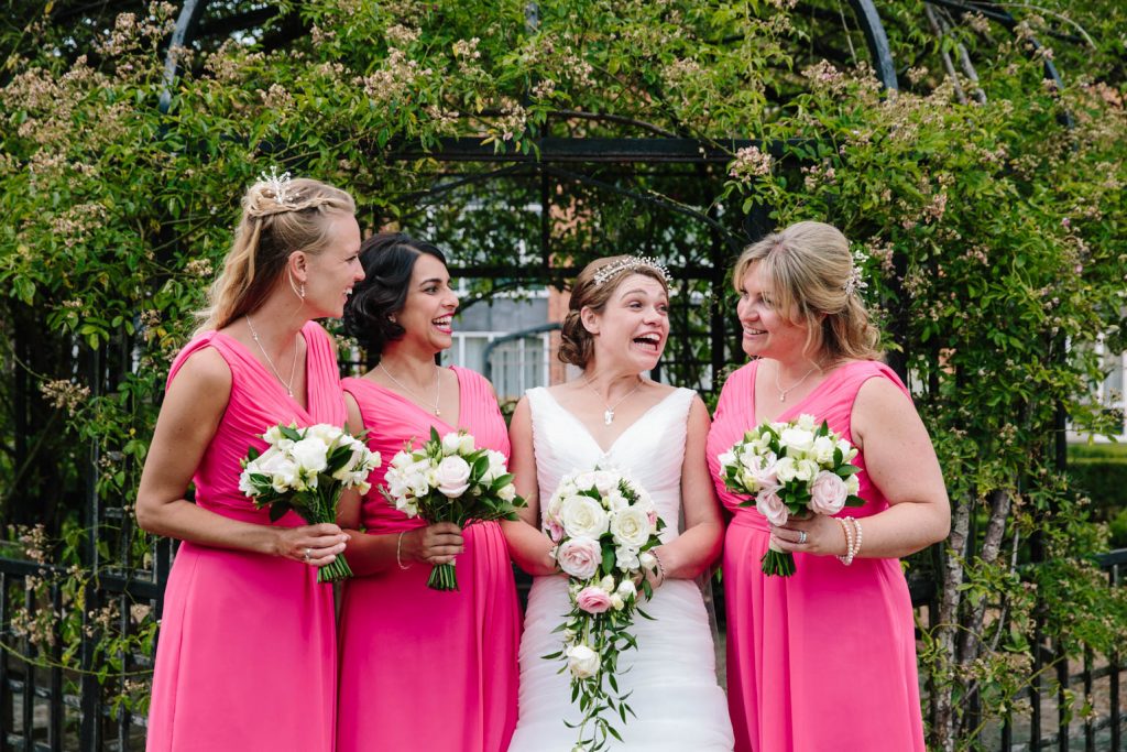 Bride with her bridesmaids laughing. At The Welcombe hotel