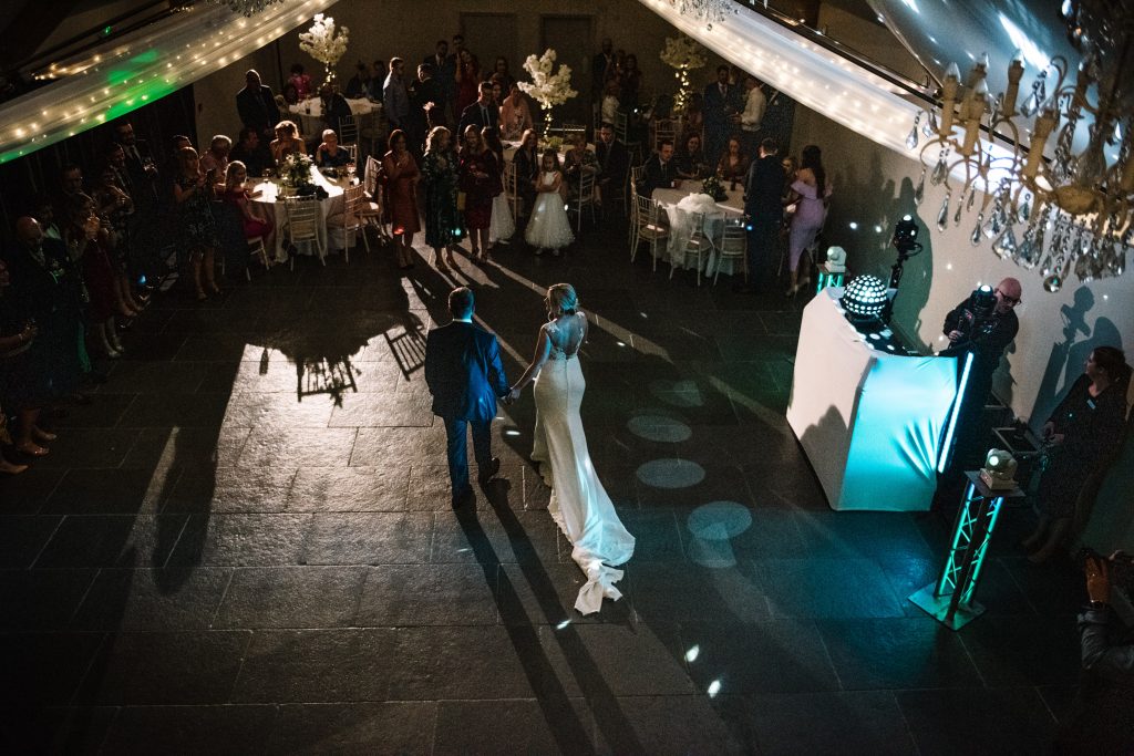 Bride and groom walking onto the dance floor for their first dance