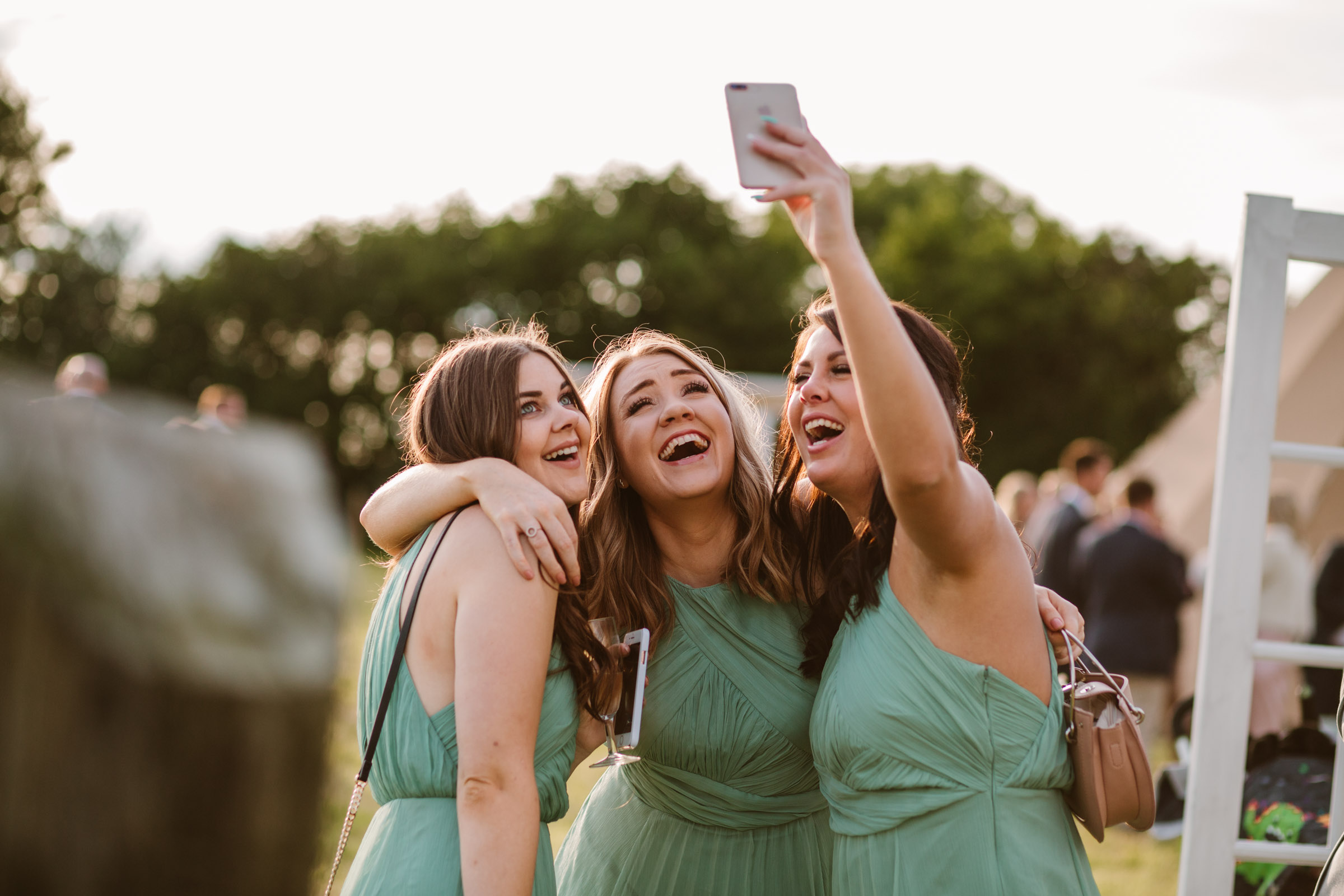 bridesmaids taking a selfie at wedding