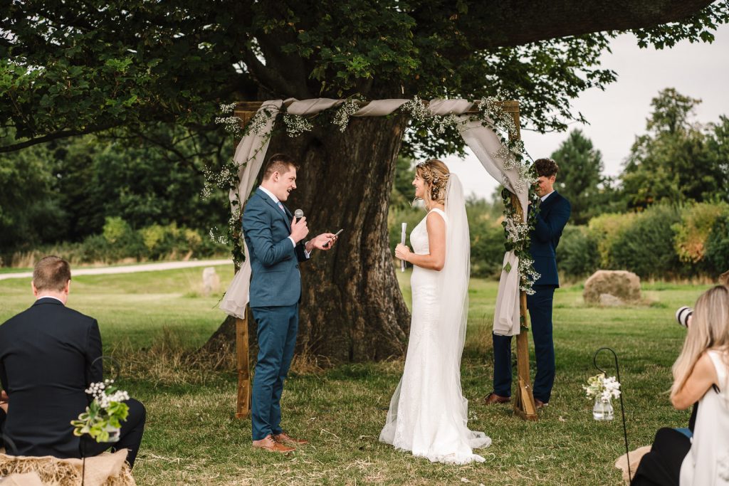 bride and groom exchanging vows at Cattows Farm wedding