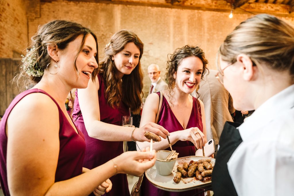 bridesmaids eating canapes at derby wedding, the riding school