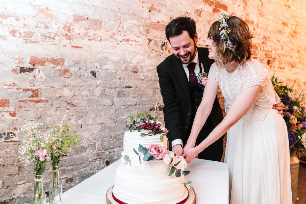 bride and groom cutting their wedding cake- Ivy house weddings 