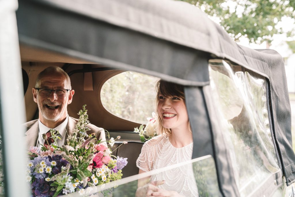 bride & her father in wedding car 
