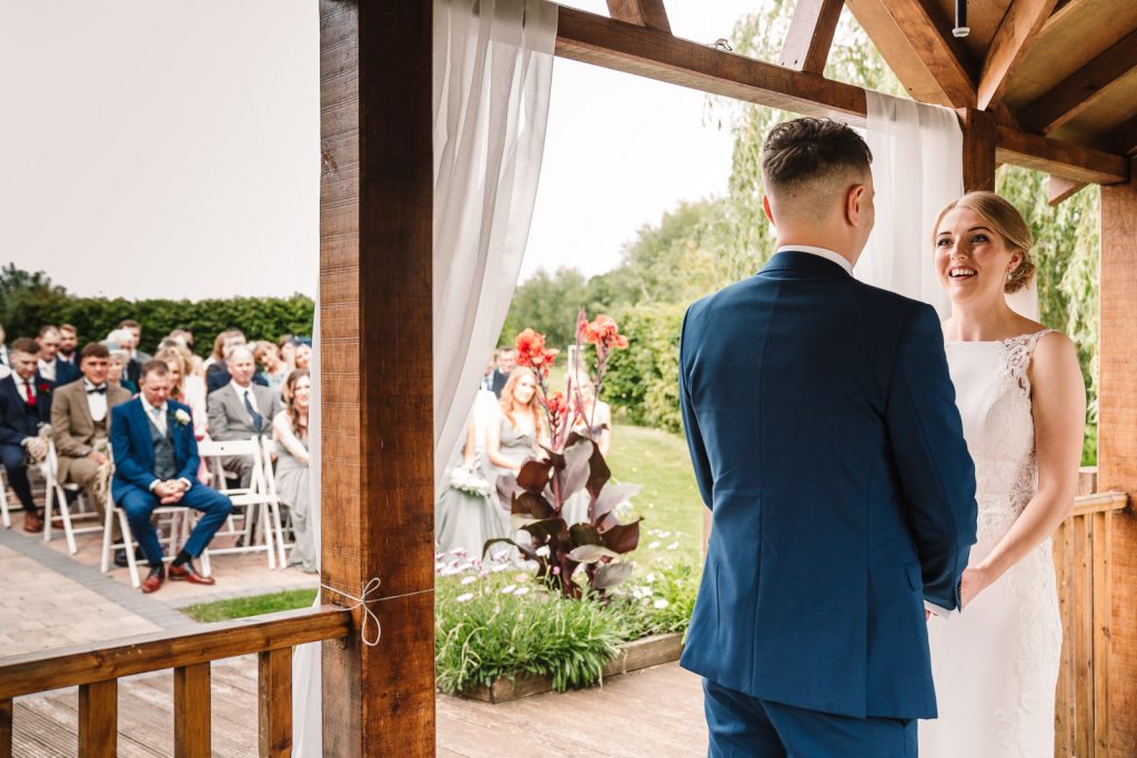bride and groom exchanging vows at wedding ceremony