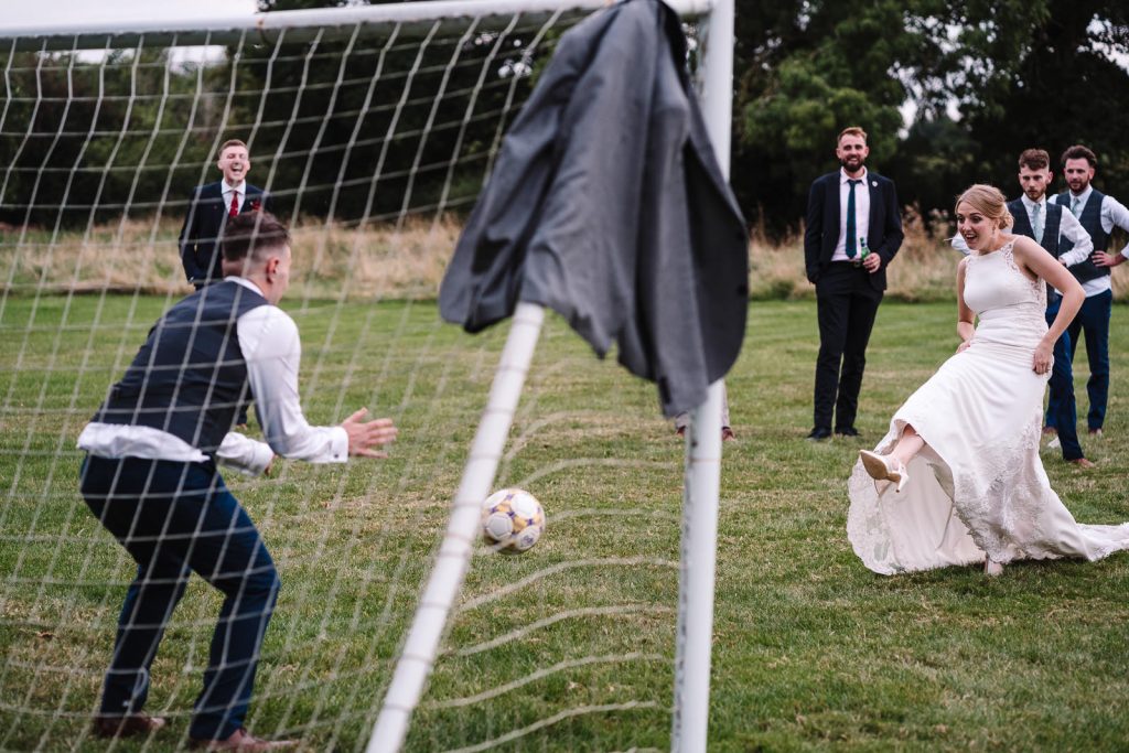 bride kicking football into goal