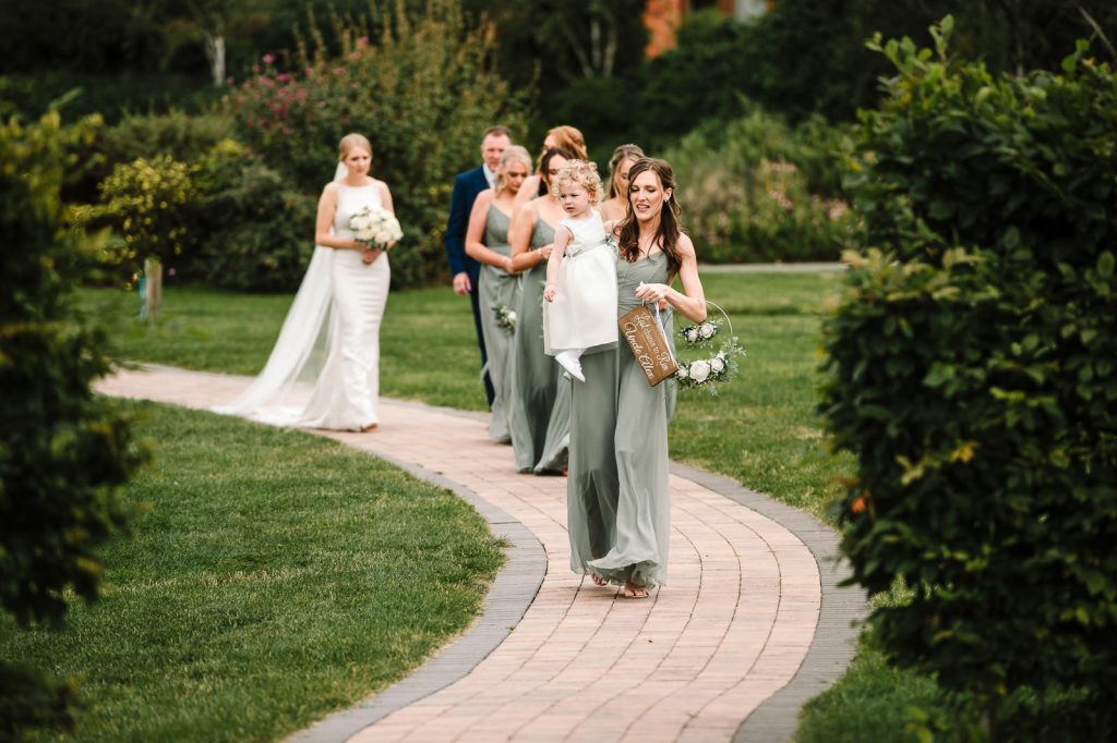 bridesmaids approaching wedding ceremony