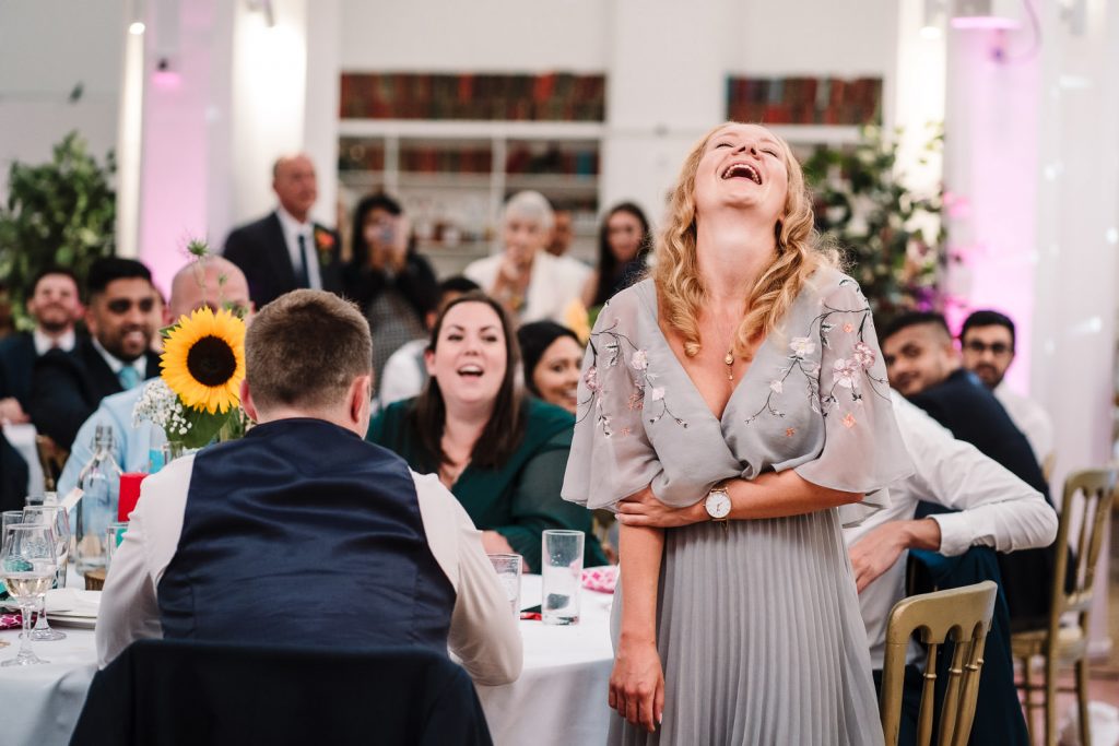 guest laughing at wedding 