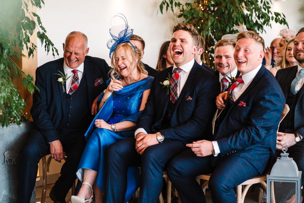 guests laughing during wedding ceremony