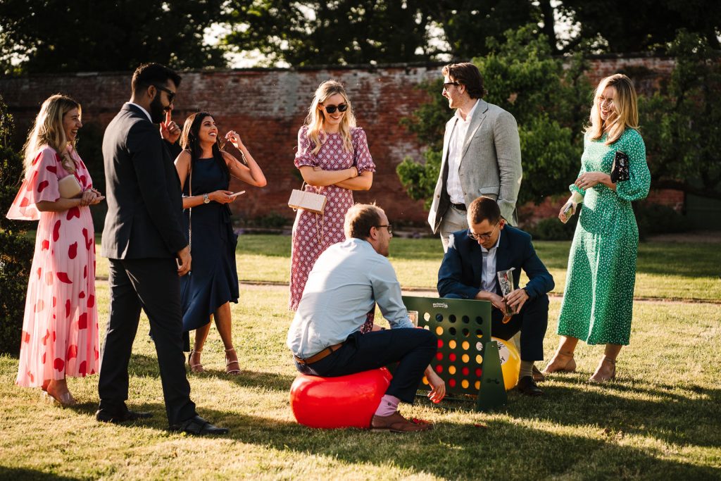 guests playing garden games on the lawn at thorpe garden wedding