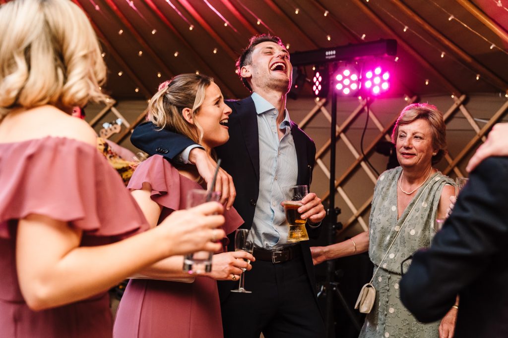 guest laughing on dancefloor at thorpe garden wedding